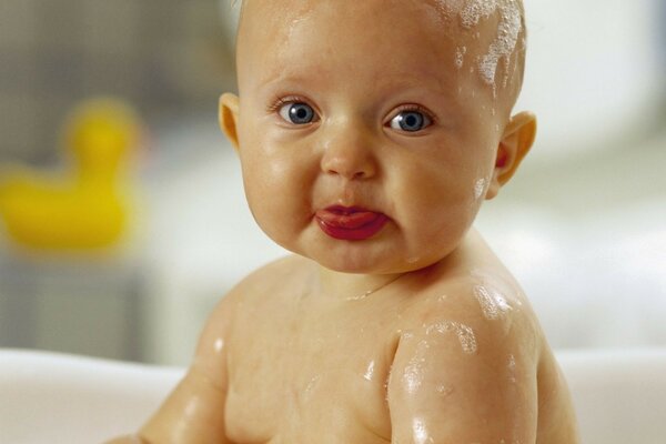 A happy child in soap suds