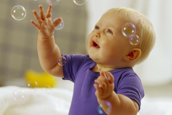 A child plays with soap bubbles