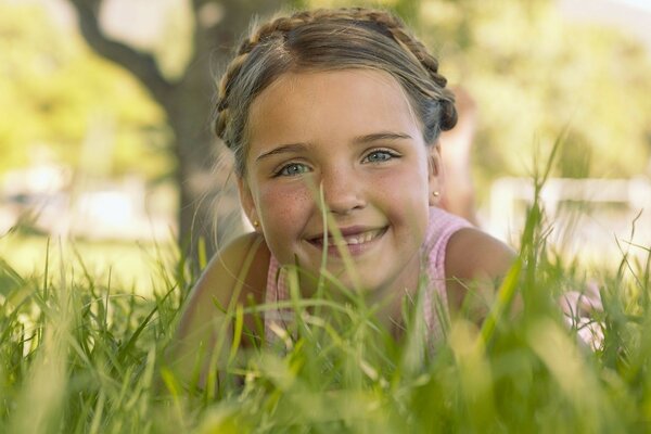 A child in nature in the grass in summer