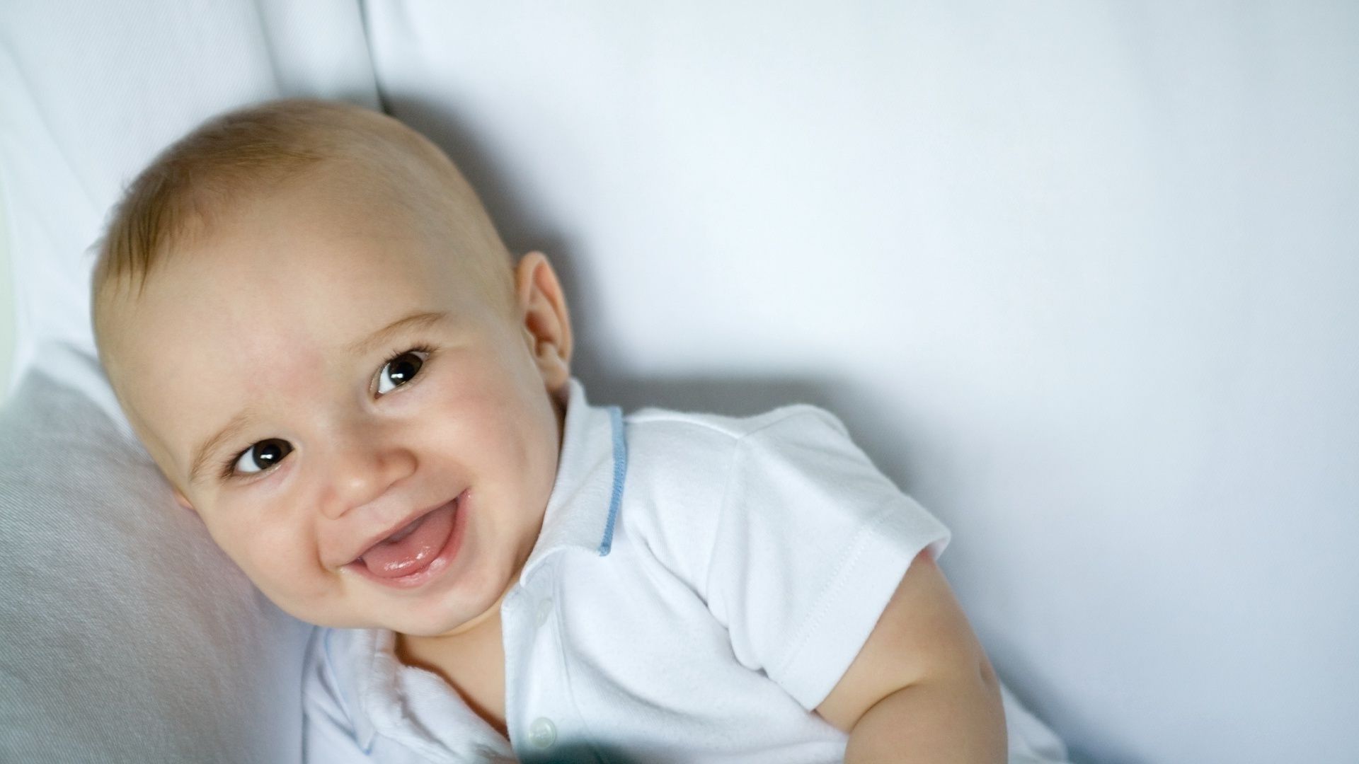 laughing children child indoors baby boy innocence cute little portrait facial expression family one toddler relaxation