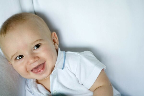 Laughing kid in a white T-shirt