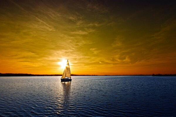 Yacht on the background of a golden sunset