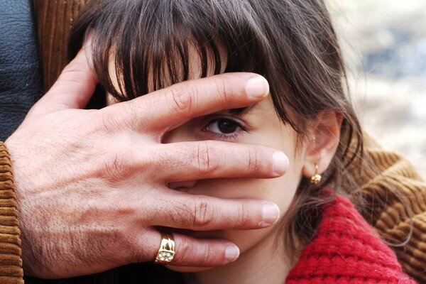 The girl s hand covering her face