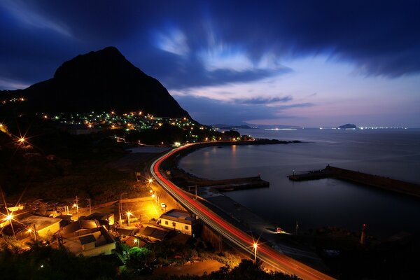 Night road along the dark sea