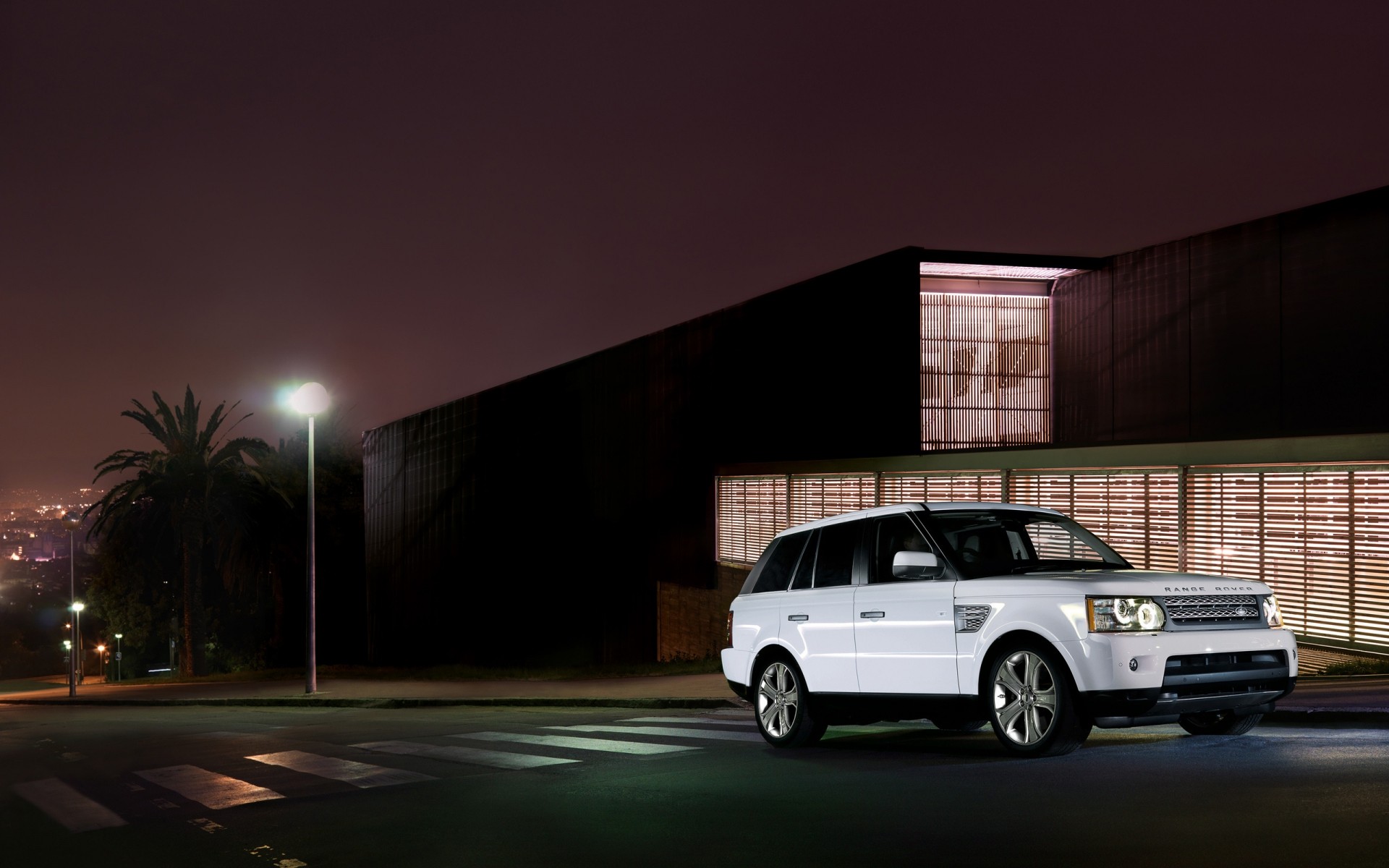 range rover car vehicle street road transportation system pavement asphalt traffic travel city blur light