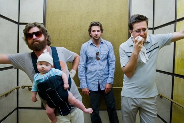 Three men riding in an elevator