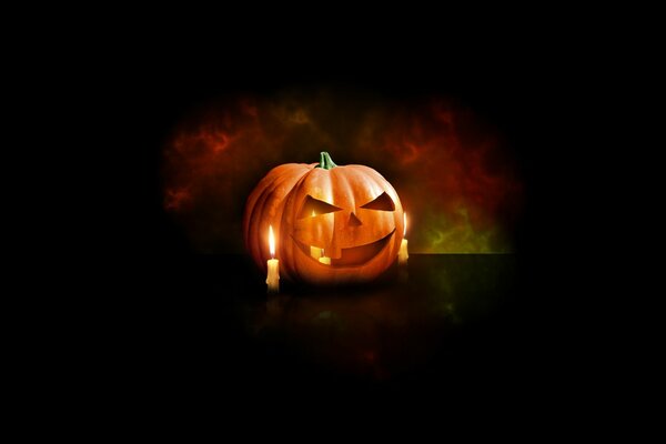 Halloween pumpkin with candles on a dark background