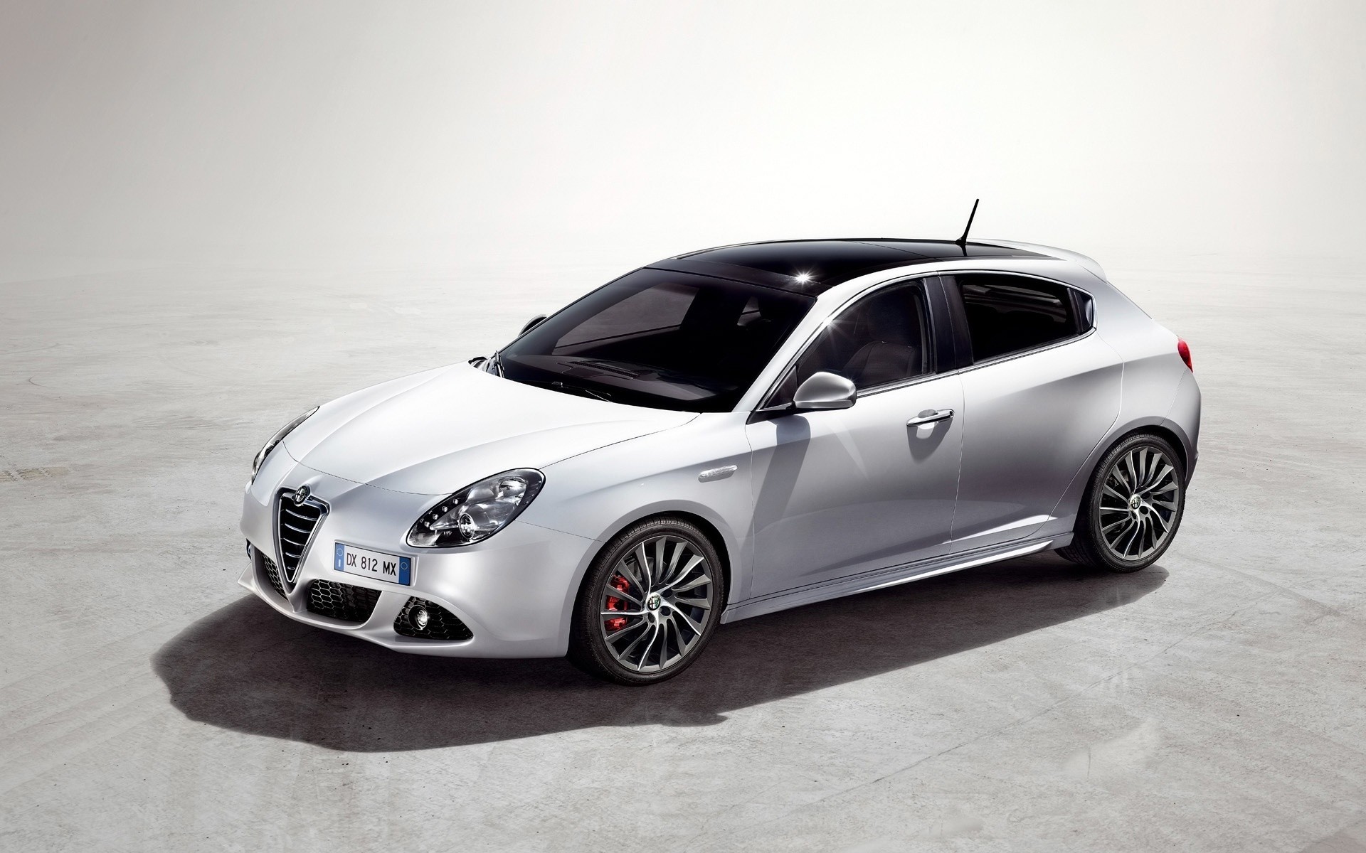 alfa romeo car vehicle automotive fast wheel coupe noon blacktop sedan hood asphalt pavement transportation system alfa romeo giulietta