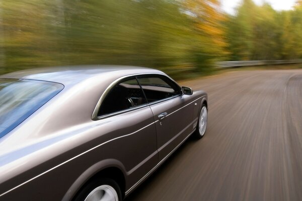 Photos of a grey Bentley in motion