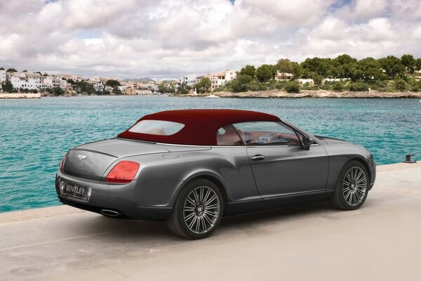 Grey Bentley convertible with red roof