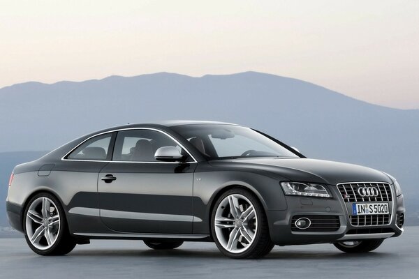 Grey audi on the background of mountains