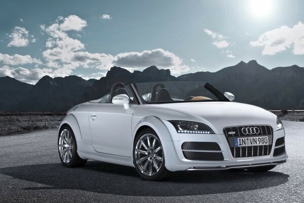 White audi on the background of mountains