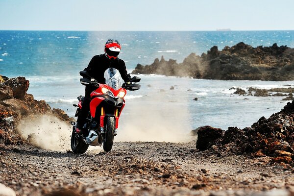 Motorcycle racer on the coast