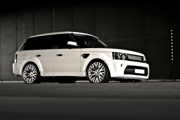 The Range Rover car is white on a gray background