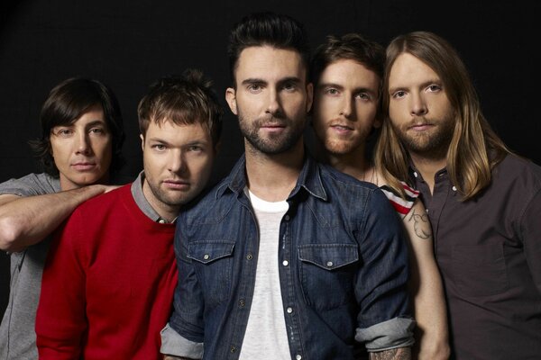 Musicians from the band maroon five pose for the camera