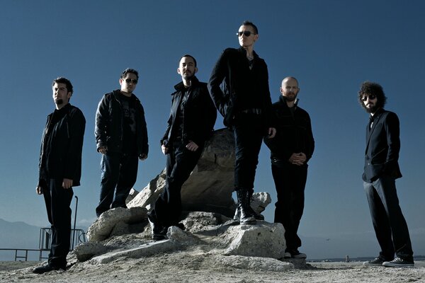 A musical group on a deserted beach