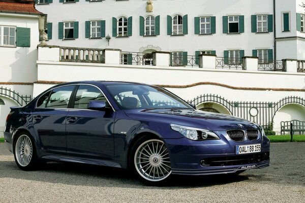 Blue BMW parked at the bridge