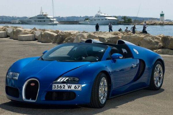 Blue Bugatti on the sea on the beach