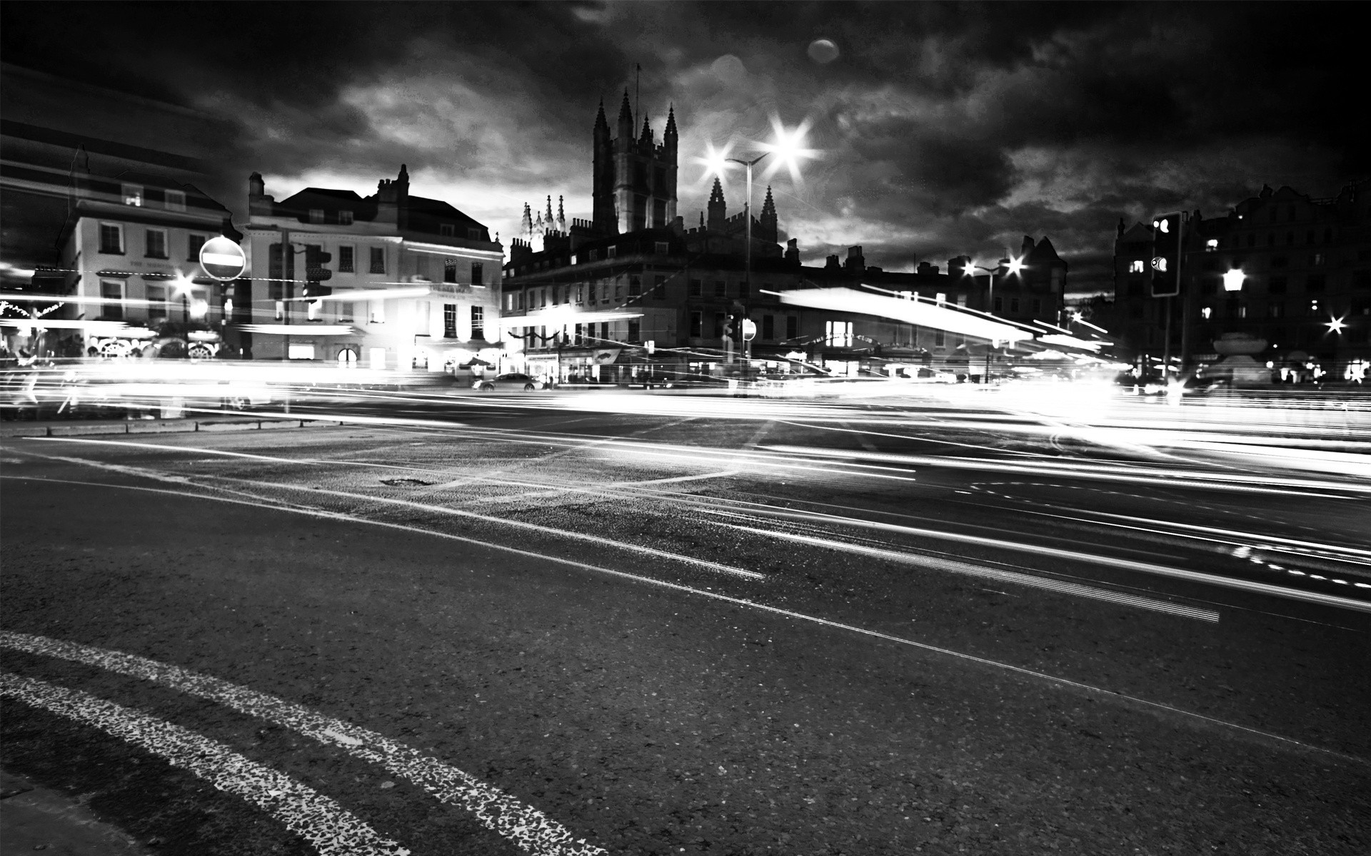 other city street monochrome car road city transportation system traffic urban downtown highway blur bus bridge travel motion fast guidance skyscraper photograph light night lights black dark