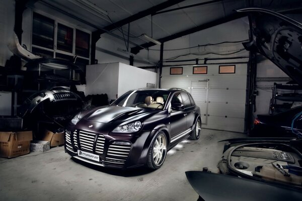 A black Porsche parked in the garage