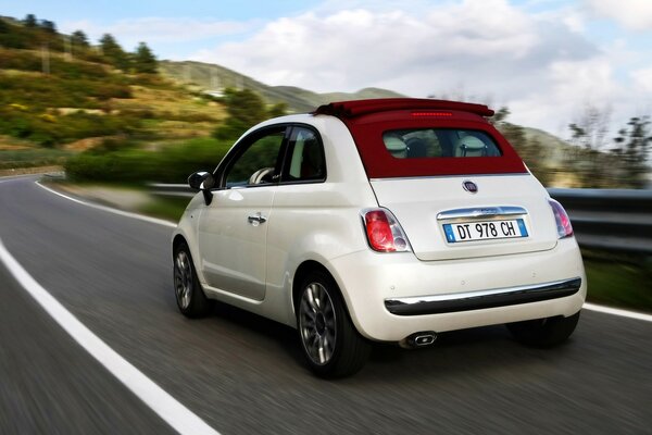 White three-door car on the highway