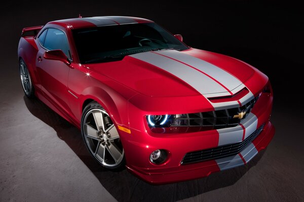 Red Chevrolet with white stripes on the hood