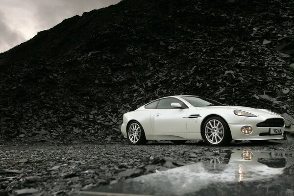 White Aston Martin on a black background