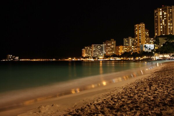 High-rise buildings at night near the coast