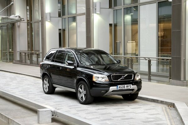 A Volvo car is parked on the sidewalk