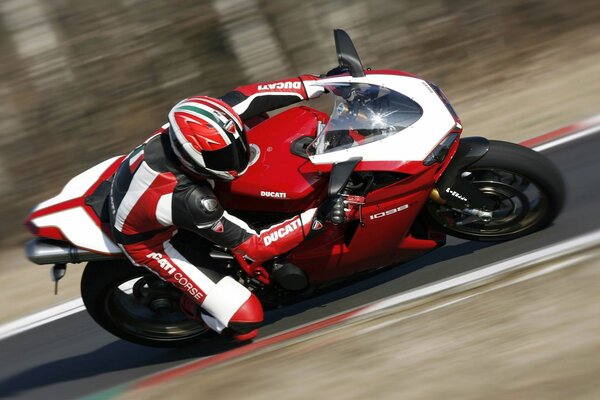 Motorcyclist on a red motorcycle on the race