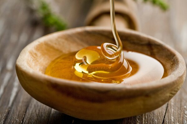 A wooden spoon filled with honey