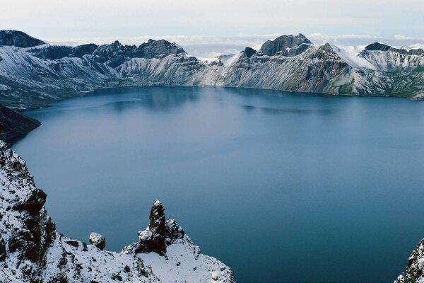 Ice winter mountains on snowy water