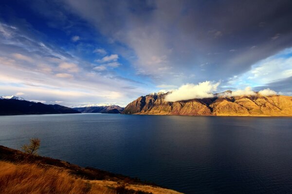 Fascinating landscape lake at sunset around a rock