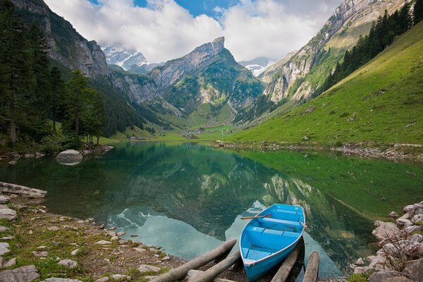 Blue boat on the background of beautiful mountains