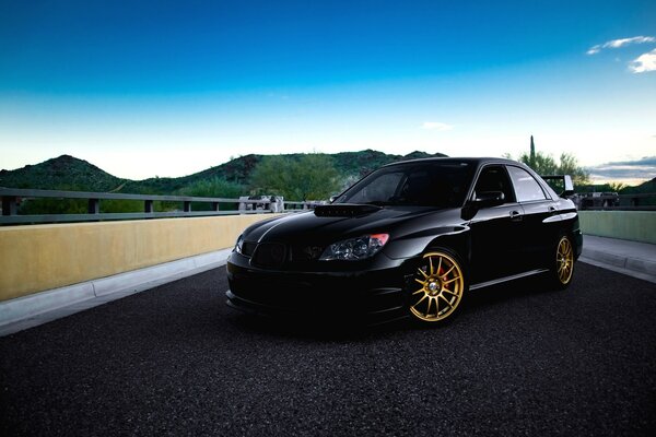 A black car on an asphalt road