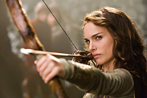 A girl aims an arrow at someone