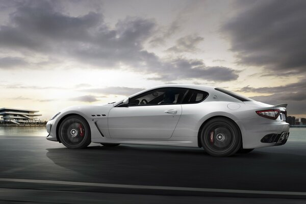 White Maserati on the background of clouds