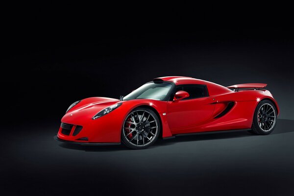 Bright red car on a black background