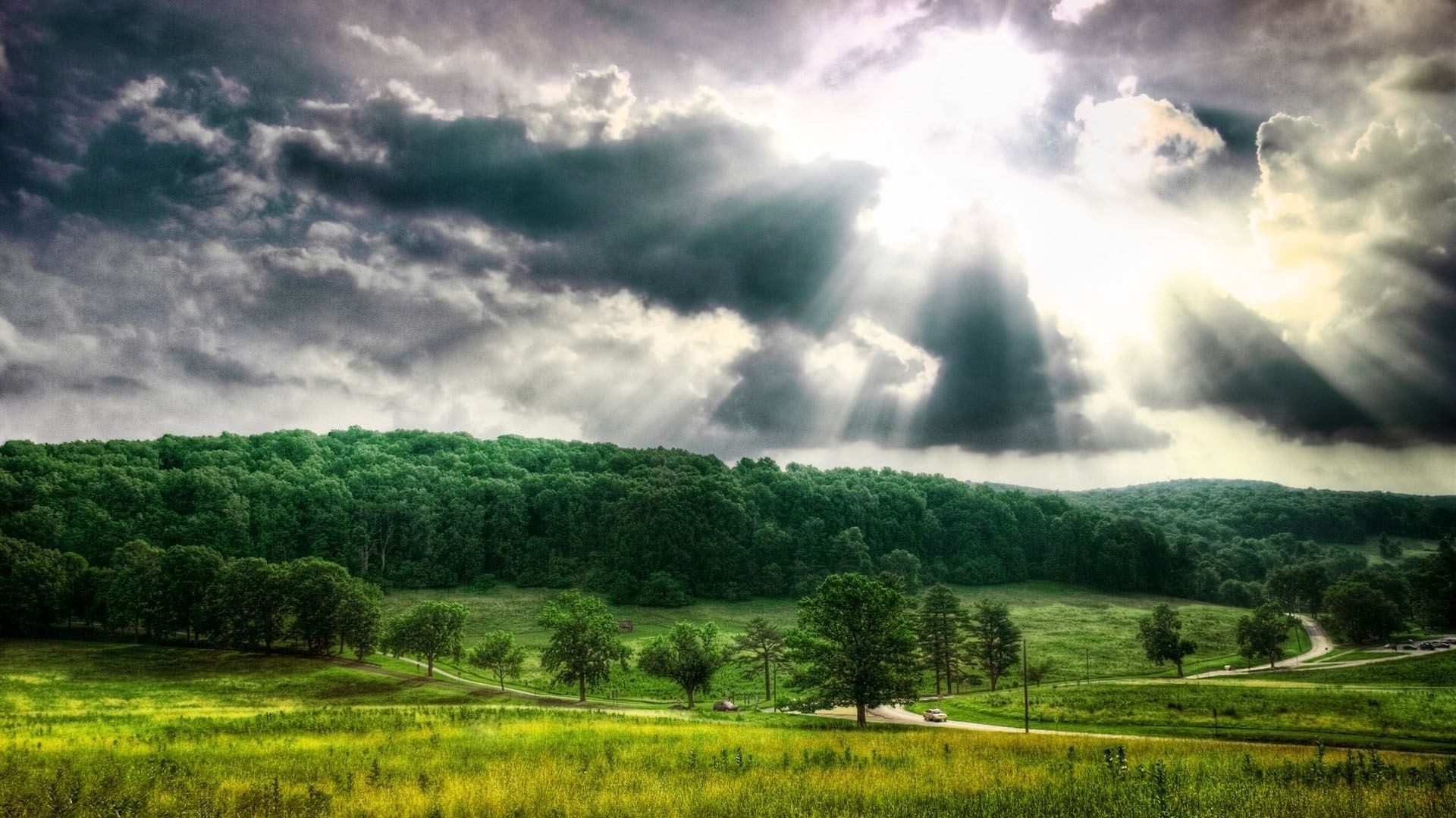 the sunlight and rays landscape nature rural sky tree agriculture outdoors countryside summer field cloud wood grass rain farm cropland cloudy fair weather storm
