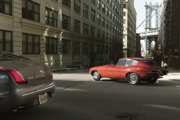 Red old car in the city at the crossroads