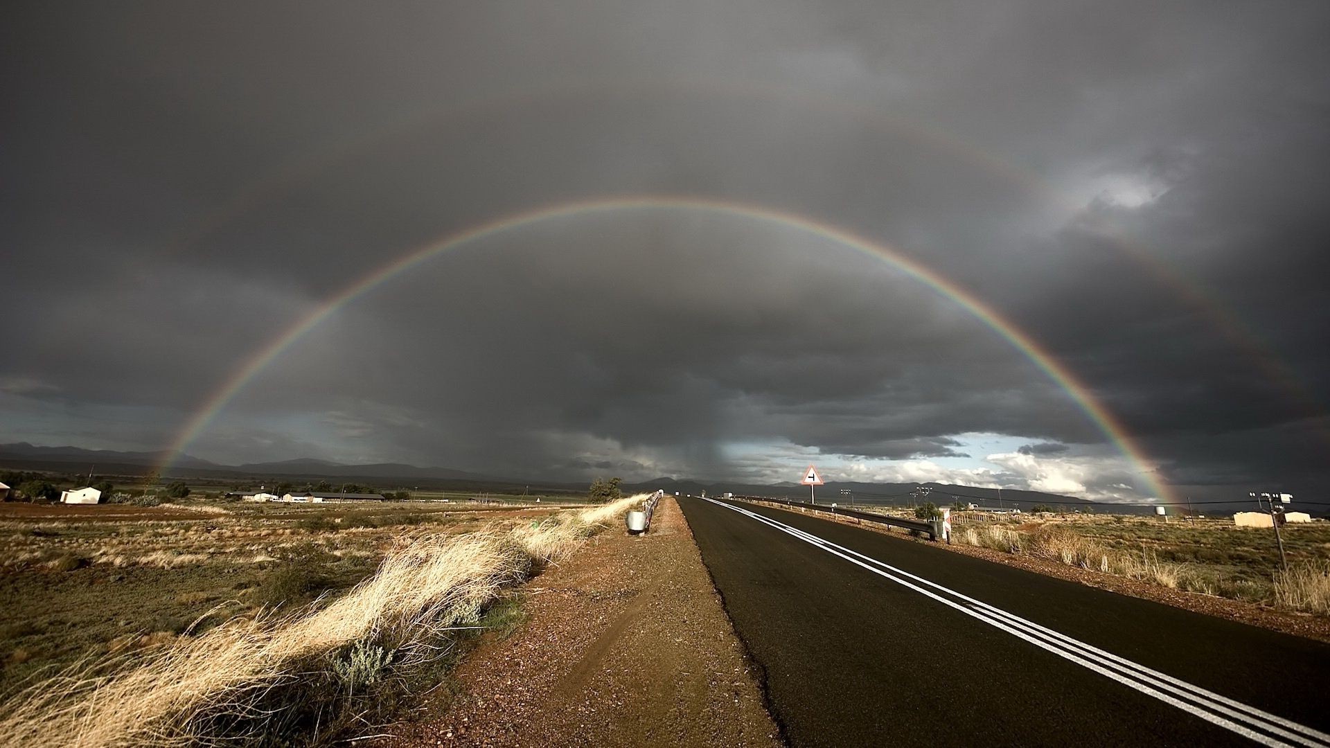 rainbow storm rain road landscape highway sky travel weather street