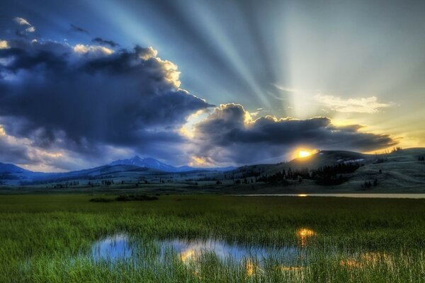 Sunset in a valley with green grass