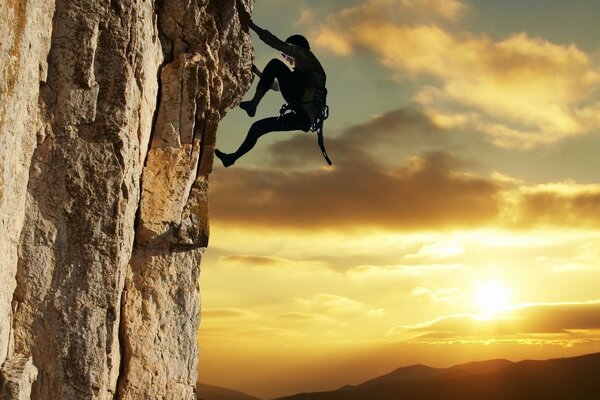 Climber climbs over sunset