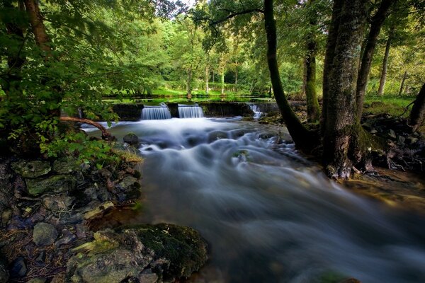 Waterfall on the river in France in spring