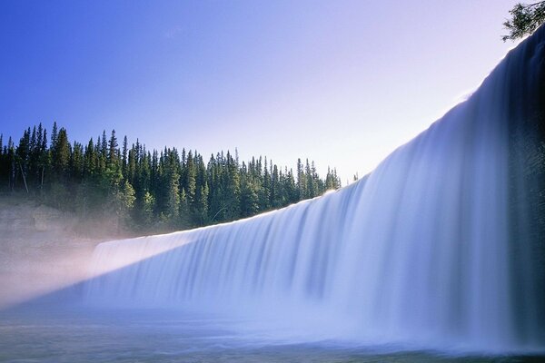 A huge majestic waterfall. Forest landscape