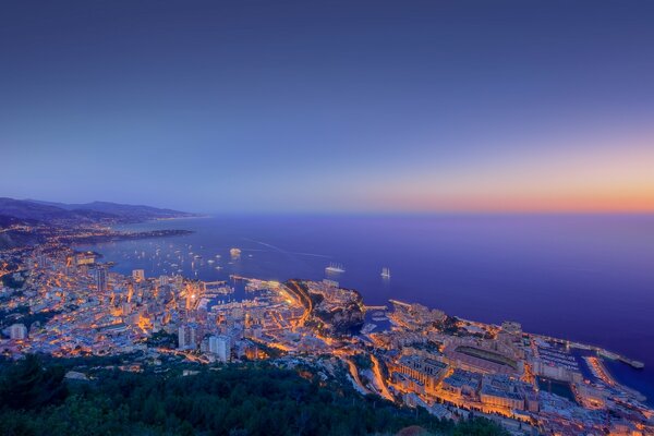 Sunset on the background of the metropolis and the ocean