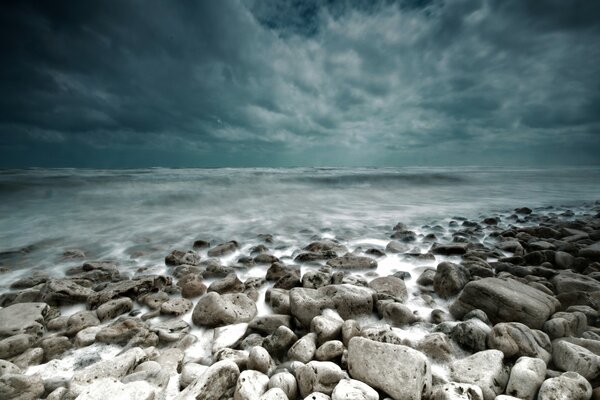 The rocky shore of a stormy gloomy ocean