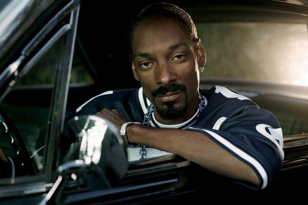 A black musician is sitting in the car