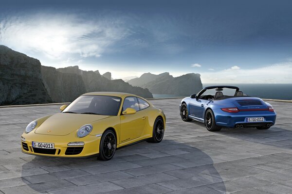 Two Porsche sports cars in different colors