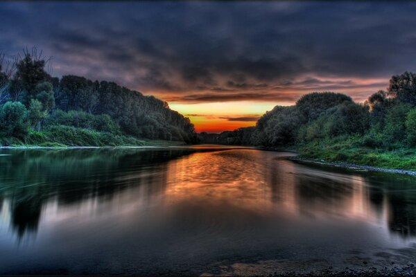 Reflection of the bright sky in the smooth surface of the night river